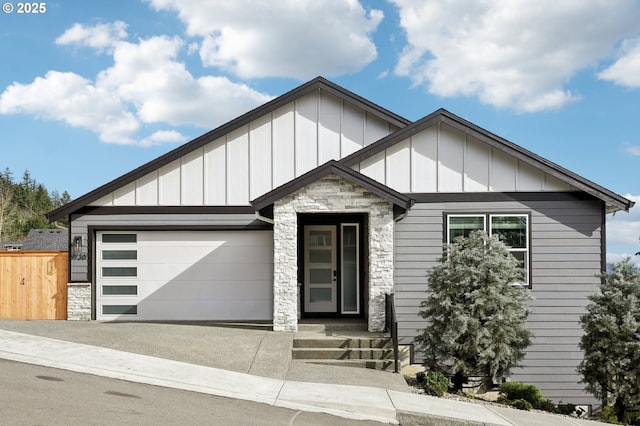 1730 N 12th St, Washougal, WA 98671 - view of front facade featuring stone siding, board and batten siding, an attached garage, and driveway