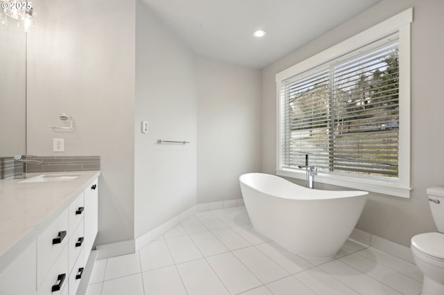 1730 N 12th St, Washougal, WA 98671 - bathroom with a freestanding bath, vanity, toilet, baseboards, and recessed lighting