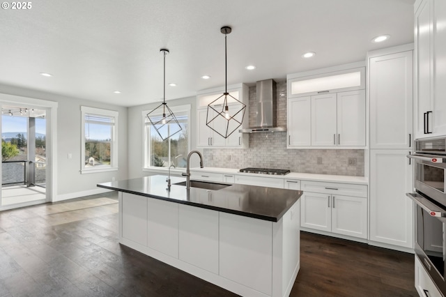 1730 N 12th St, Washougal, WA 98671 - kitchen with wall chimney range hood, a sink, appliances with stainless steel finishes, dark wood-type flooring, and backsplash