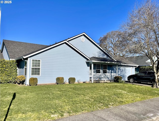 view of side of home featuring a garage, covered porch, and a lawn