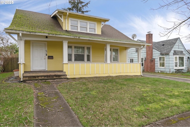 bungalow-style home with a front yard and a porch