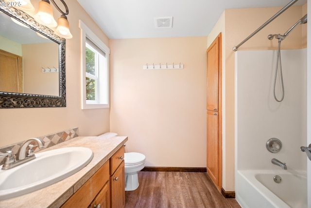 1602 NE 16th Ct, Battle Ground, WA 98604 - full bathroom featuring wood finished floors, vanity, washtub / shower combination, toilet, and baseboards