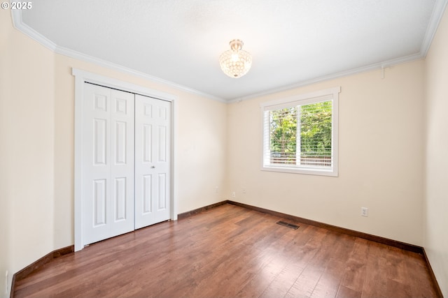 1602 NE 16th Ct, Battle Ground, WA 98604 - unfurnished bedroom featuring wood finished floors, baseboards, crown molding, and a closet