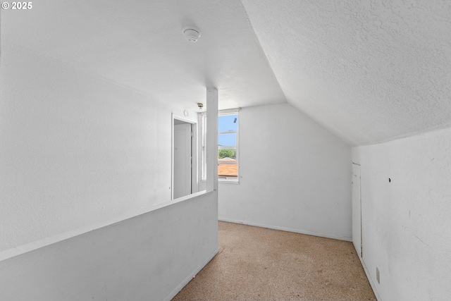 180 W Second Ave, Sutherlin, OR 97479 - additional living space with vaulted ceiling, carpet flooring, and a textured ceiling