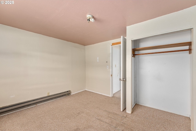 180 W Second Ave, Sutherlin, OR 97479 - unfurnished bedroom featuring a baseboard heating unit, carpet, a closet, and baseboards