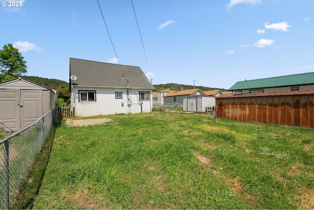180 W Second Ave, Sutherlin, OR 97479 - rear view of house featuring a shed, an outbuilding, and stucco siding