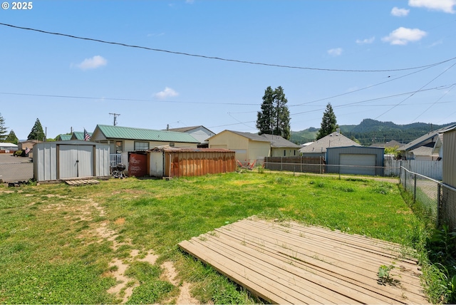 180 W Second Ave, Sutherlin, OR 97479 - view of yard featuring a storage shed, an outdoor structure, and a wooden deck