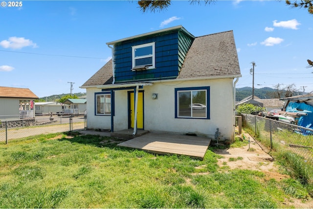 180 W Second Ave, Sutherlin, OR 97479 - view of front of home with stucco siding, roof with shingles, a deck, and a gate