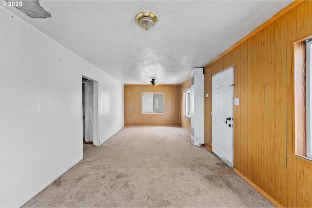 180 W Second Ave, Sutherlin, OR 97479 - carpeted spare room with ceiling fan, wooden walls, and baseboards