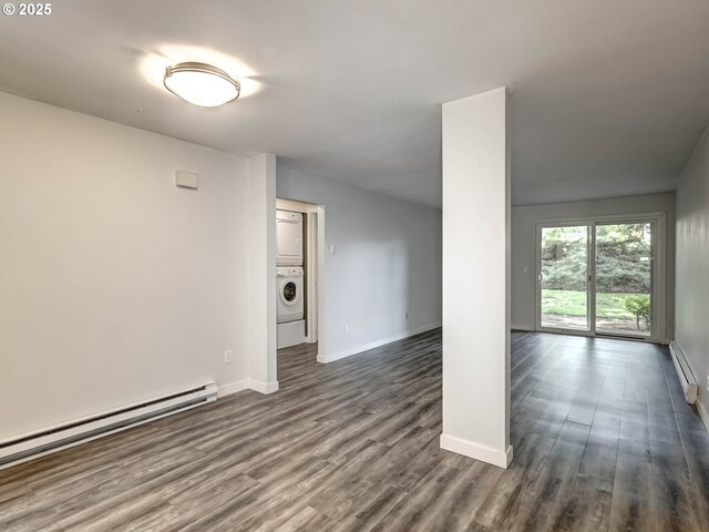 12642 NW Barnes Rd Unit 10, Portland, OR 97229 - spare room featuring stacked washer / drying machine, a baseboard radiator, and dark wood-style floors