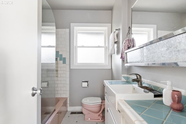 bathroom with tile patterned floors, visible vents, a healthy amount of sunlight, and toilet