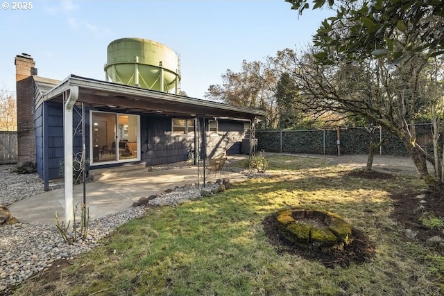 view of yard with a patio, a fire pit, and a fenced backyard