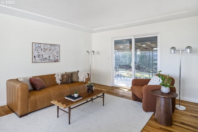 living room featuring baseboards and wood finished floors