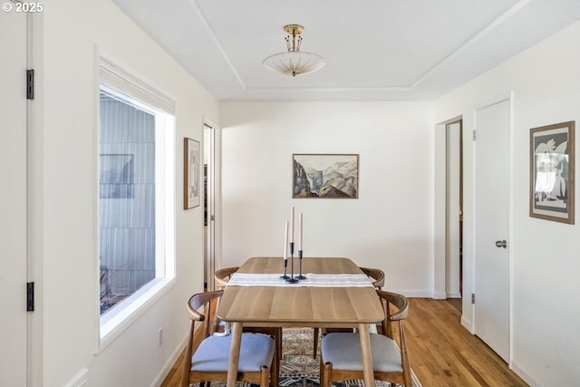 dining room with light wood-style flooring and baseboards