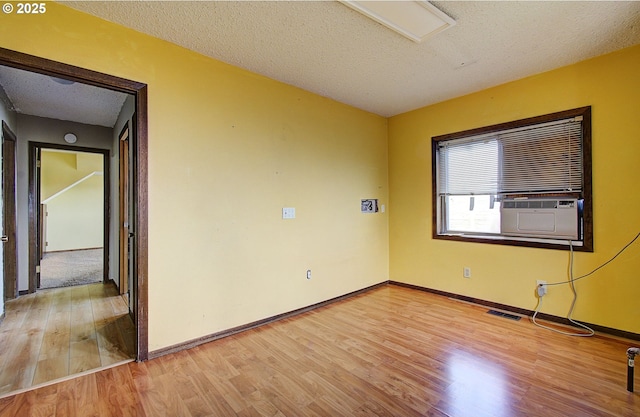 8400 Cason Rd, Gladstone, OR 97027 - unfurnished room with light wood-style flooring, a textured ceiling, and cooling unit