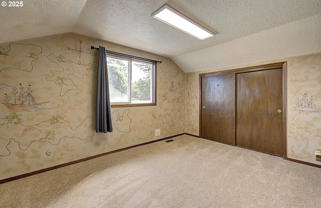 8400 Cason Rd, Gladstone, OR 97027 - unfurnished bedroom with lofted ceiling, a textured ceiling, carpet, and a closet