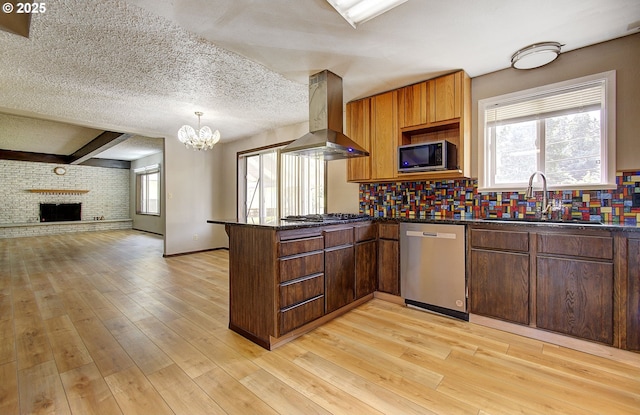 8400 Cason Rd, Gladstone, OR 97027 - kitchen with appliances with stainless steel finishes, island exhaust hood, a peninsula, decorative backsplash, and a chandelier