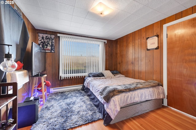 1648 Augusta St, Eugene, OR 97403 - bedroom with a baseboard heating unit, wood finished floors, and wood walls