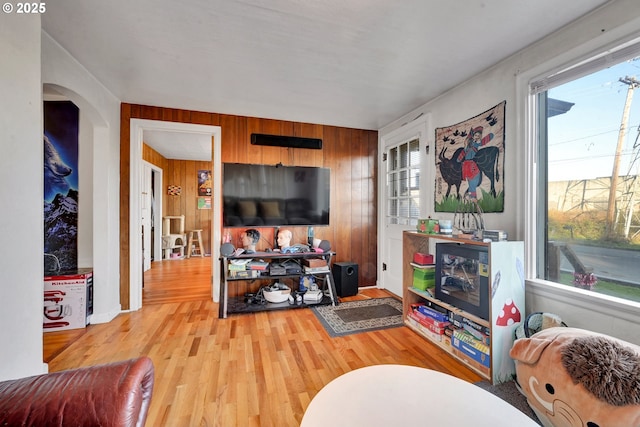 1648 Augusta St, Eugene, OR 97403 - living room with wooden walls, wood finished floors, and arched walkways