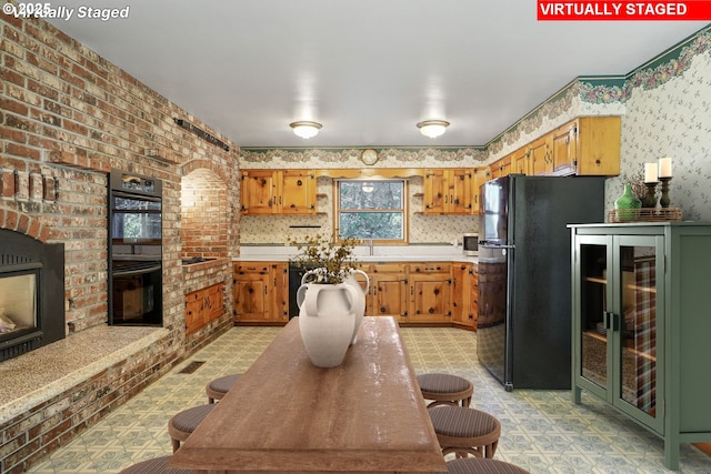 kitchen with black appliances, beverage cooler, light floors, and light countertops