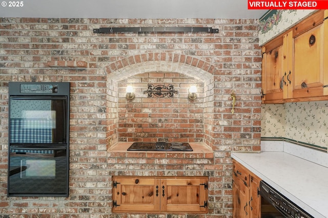 kitchen with brown cabinetry, black appliances, and light countertops