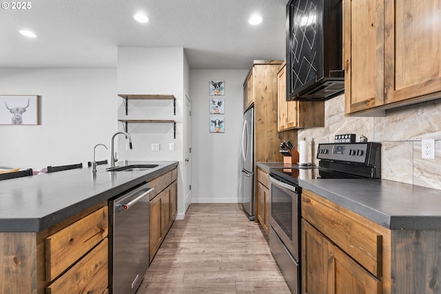 125 N 44th Pl, Ridgefield, WA 98642 - kitchen with appliances with stainless steel finishes, dark countertops, open shelves, light wood-style floors, and recessed lighting