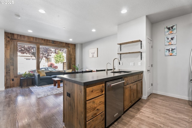 125 N 44th Pl, Ridgefield, WA 98642 - kitchen with stainless steel dishwasher, dark countertops, open shelves, light wood finished floors, and recessed lighting
