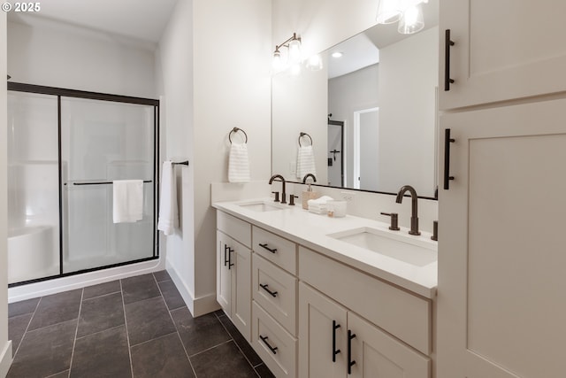 19386 Juniper Ct, Oregon City, OR 97045 - bathroom featuring double vanity, baseboards, a shower stall, and a sink