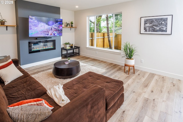 19386 Juniper Ct, Oregon City, OR 97045 - living room featuring a glass covered fireplace, baseboards, recessed lighting, and wood finished floors