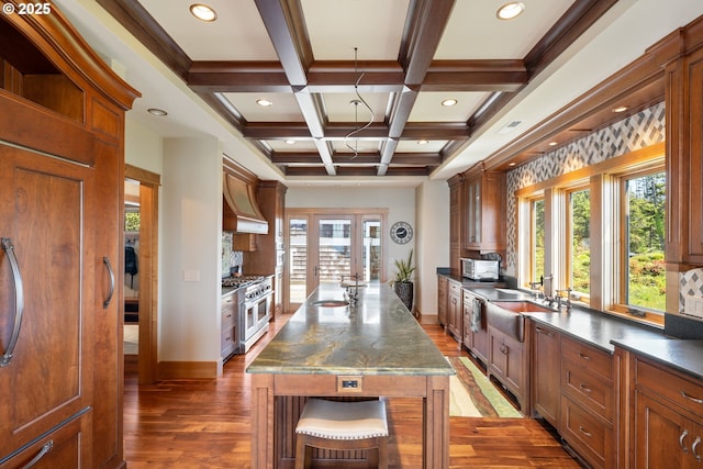 280 Fall Creek Dr, Oceanside, OR 97134 - kitchen with double oven range, wood finished floors, beam ceiling, baseboards, and a sink
