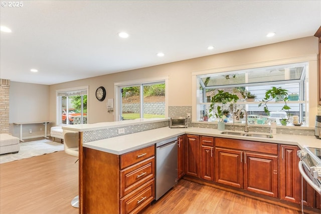 8311 Greenann Ct, Gladstone, OR 97027 - kitchen featuring appliances with stainless steel finishes, light wood-style flooring, light countertops, a peninsula, and recessed lighting