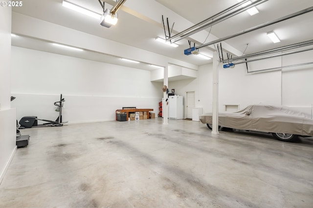12345 SE Wagner St, Happy Valley, OR 97086 - garage featuring freestanding refrigerator and a garage door opener