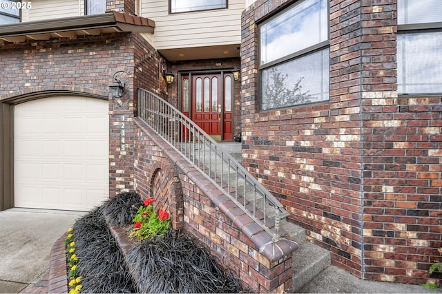 12345 SE Wagner St, Happy Valley, OR 97086 - view of exterior entry with brick siding, concrete driveway, and an attached garage