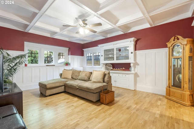 living room featuring coffered ceiling, light hardwood / wood-style floors, and beamed ceiling