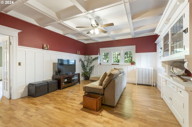 living room with light hardwood / wood-style flooring, radiator, beam ceiling, ceiling fan, and coffered ceiling