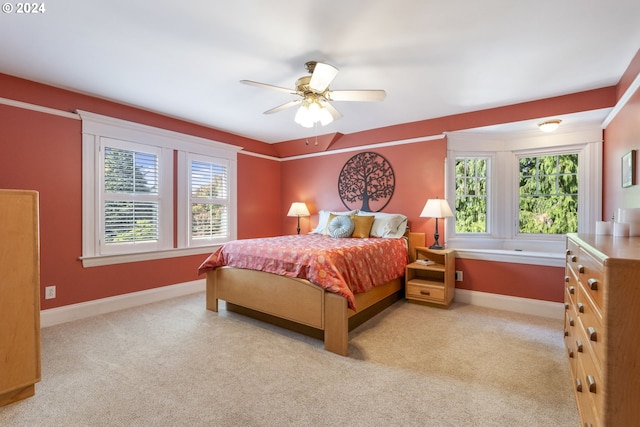 bedroom featuring light carpet and ceiling fan