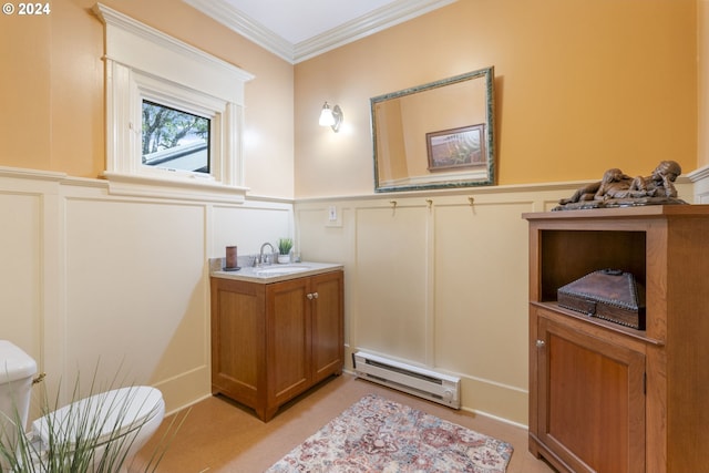 bathroom with toilet, a baseboard heating unit, ornamental molding, and vanity