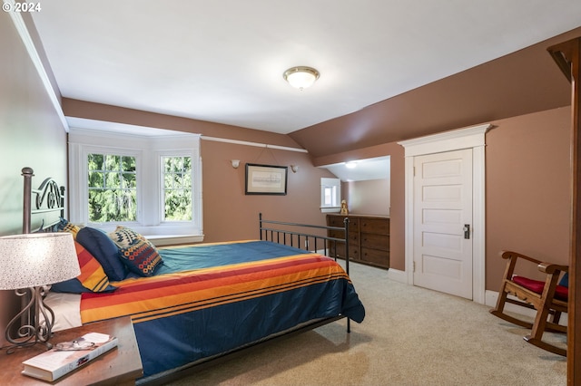 carpeted bedroom featuring vaulted ceiling