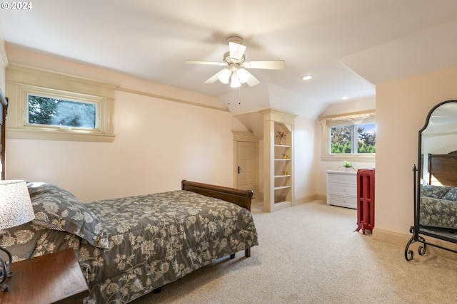 bedroom with ceiling fan, vaulted ceiling, and light carpet