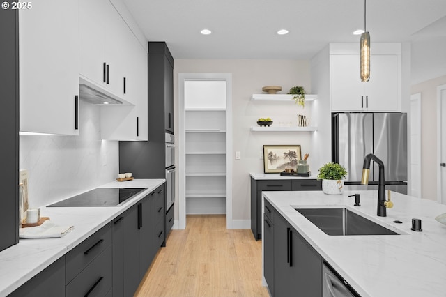6803 NW 24th Ct, Vancouver, WA 98665 - kitchen featuring freestanding refrigerator, black electric stovetop, white cabinetry, pendant lighting, and light wood finished floors