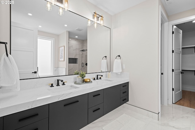 6803 NW 24th Ct, Vancouver, WA 98665 - full bath featuring double vanity, a shower stall, marble finish floors, a walk in closet, and recessed lighting