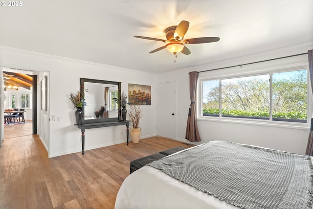 32890 Hillside Acres Rd, Gold Beach, OR 97444 - bedroom featuring crown molding, multiple windows, wood finished floors, and baseboards