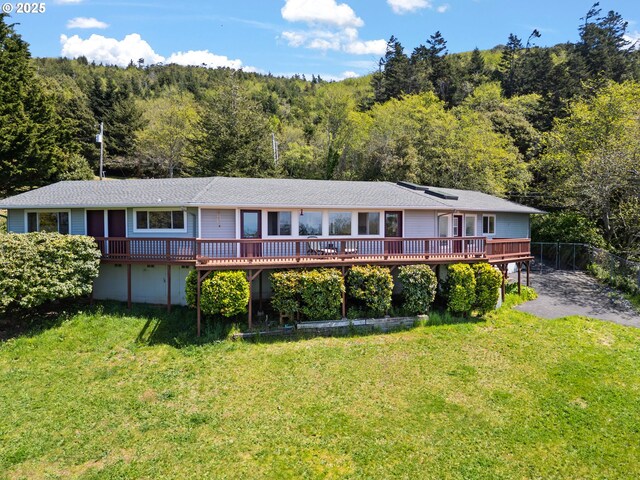 32890 Hillside Acres Rd, Gold Beach, OR 97444 - view of front facade featuring a front lawn, a wooden deck, and a wooded view
