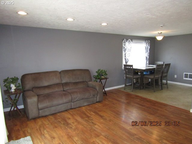 living room featuring hardwood / wood-style floors and a textured ceiling