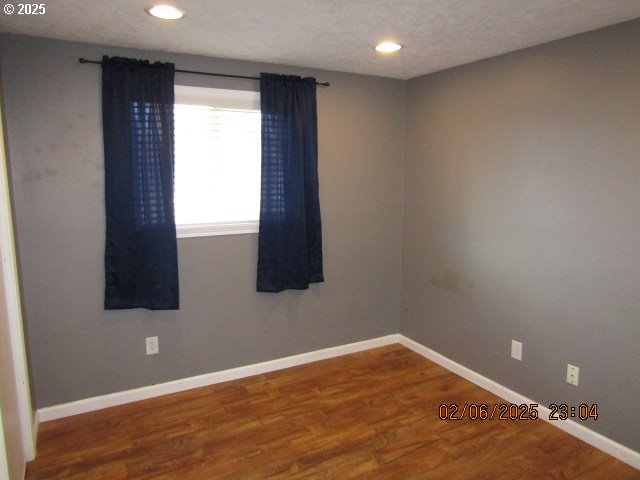 empty room featuring hardwood / wood-style flooring