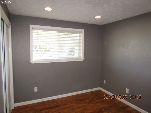 unfurnished room featuring dark hardwood / wood-style flooring