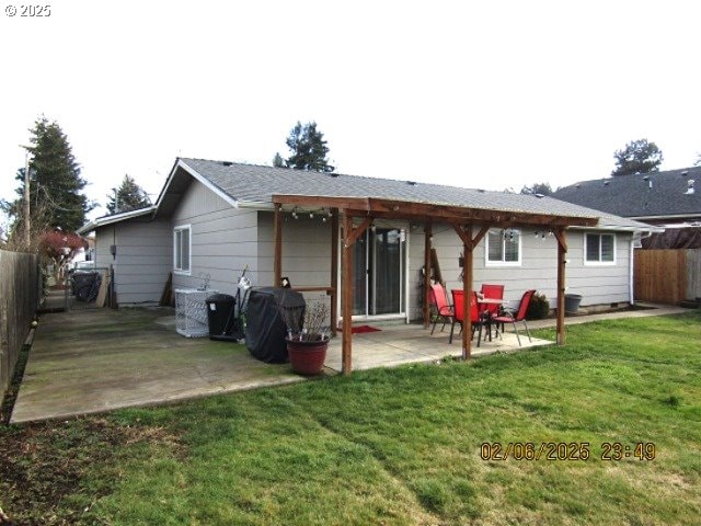 back of property with a patio area and a lawn