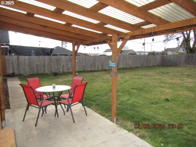 view of yard with a patio, a pergola, and a trampoline