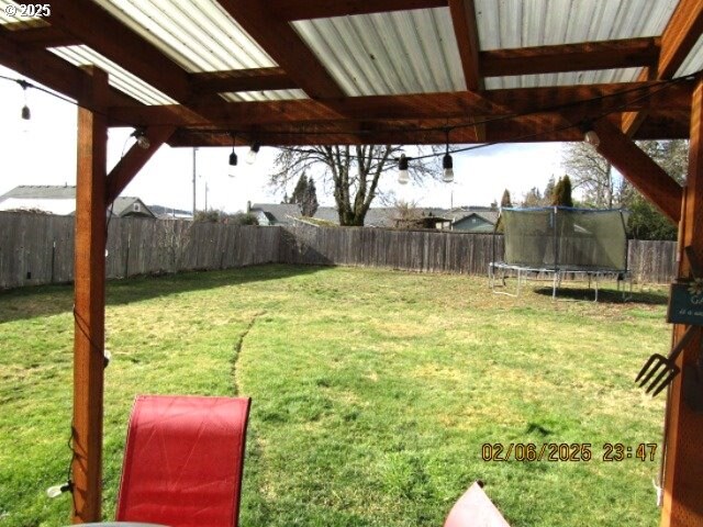 rear view of house featuring a lawn and a patio area