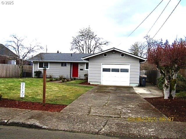 ranch-style house with a garage and a front yard